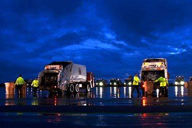 Trash Project Trucks under stormy sky